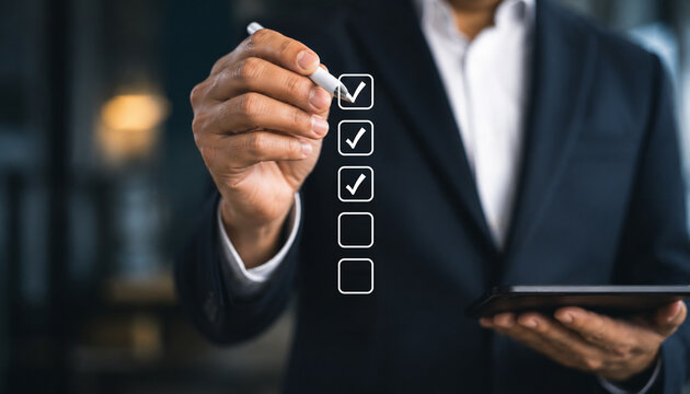 Businessman use pen to tick correct sign mark in checkbox for quality document control checklist and business approve project concept. 