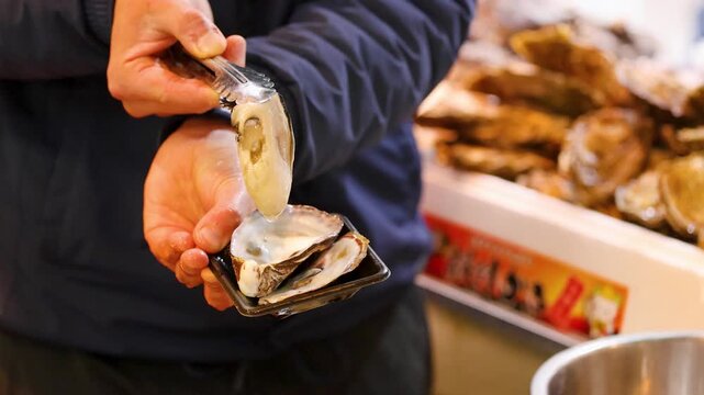 Fresh Oyster Being Served at Tsukiji Outer Market in Tokyo