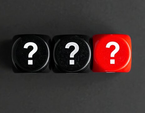 Three dice in a row with question mark faces; two black and one red