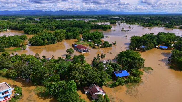 From an aerial view, floodwaters inundate a village in Sivasagar, Assam. Submerging homes, agricultural fields and roads across the landscape.