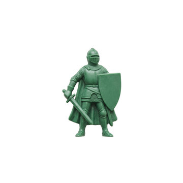 Small green plastic toy knight figurine with sword and shield isolated on white background.