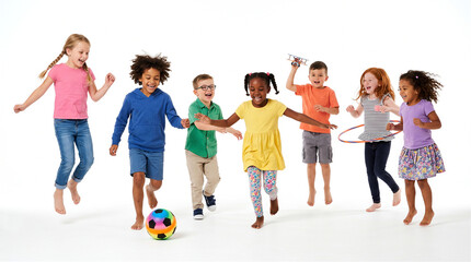 Obraz premium Children of diverse ethnic backgrounds jump and play together with a colorful soccer ball against a white studio background.