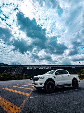 Nakhon Nayok, Thailand &ndash; May 18, 2026: pickup truck Ford Ranger White pickup truck parked in front of Khun Dan Prakan Chon Dam with dramatic sky