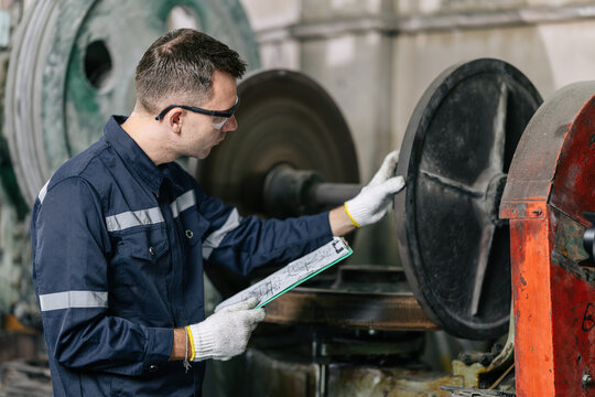 Professional Engineer Worker Schedule Inspecting Machine condition for safety in Heavy Industry Machinery Factory
