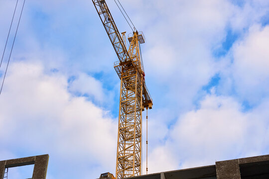 Yellow tower cranes at a construction site of a modern building