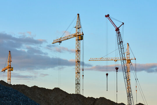 Modern residential apartment buildings under construction with cranes