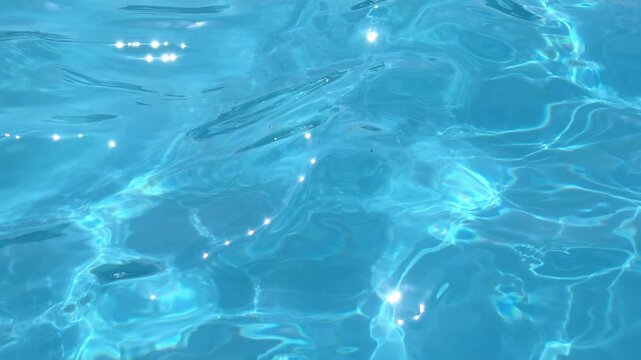Water ripples in clear pool under sunlight during midday hours