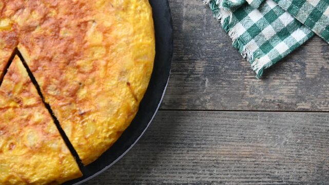Spanish potato omelette rotating on plate