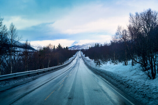 POV driving on empty asphalt road during winter road trip in Lofoten Norway