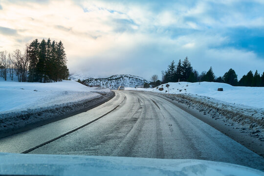POV winter road trip driving on icy asphalt road in Lofoten Norway