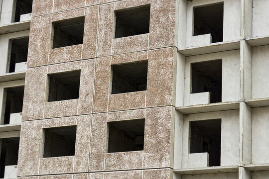 Focused view of raw concrete architectural elements. Close examination of unfinished concrete surface with panel details and textures