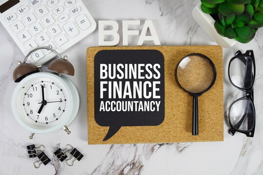 BFA - Business Finance and Accountancy acronym with calculator, alarm clock and magnifying glass, Financial concept background