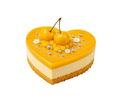Heart shaped yellow mango mousse cake with mirror glaze and yellow cherries on top.