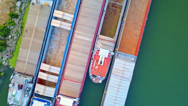 Aerial view of transport boats on the Danube River. Transport barges on the Danube River. Drone view of transport boats on a river