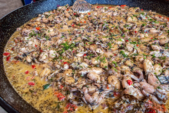 Background with frog legs in a big pan and ready for cooking. Specific for mediterranean 