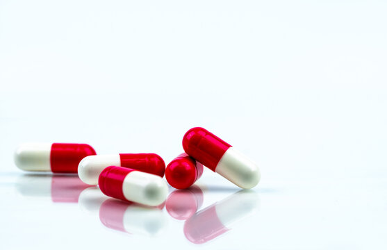 Minimal pink and white prescription capsule medication on white background, pharmaceutical healthcare concept for pharmacy, hospital treatment and medical industry. Drug industry. Medical Innovation.