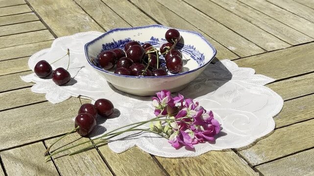 Fresh Cherries Falling into a Vintage Bowl in Slow Motion