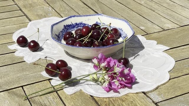 Fresh Cherries Falling into a Vintage Bowl in Slow Motion