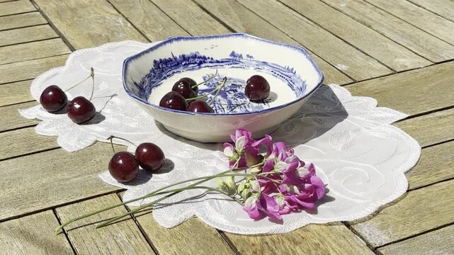 Fresh Cherries Falling into a Vintage Bowl in Slow Motion