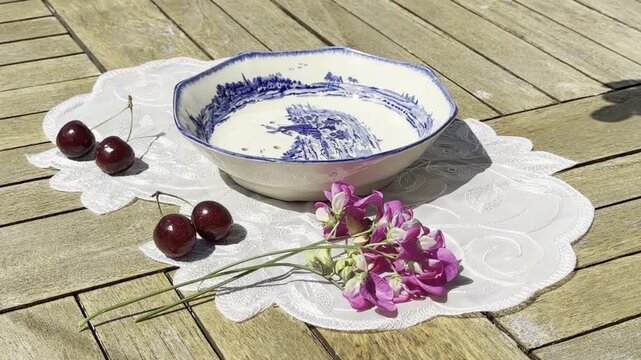 Fresh Cherries Falling into a Vintage Bowl in Slow Motion