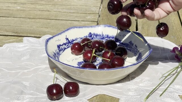 Fresh Cherries Falling into a Vintage Bowl in Slow Motion