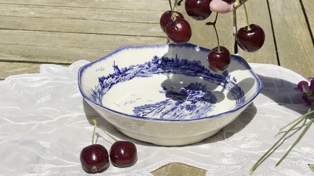 Fresh Cherries Falling into a Vintage Bowl in Slow Motion