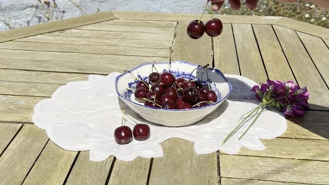 Fresh Cherries Falling into a Vintage Bowl in Slow Motion