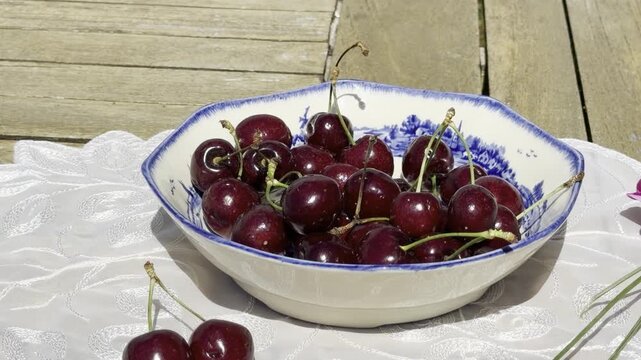 Fresh Cherries Falling into a Vintage Bowl in Slow Motion