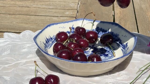 Fresh Cherries Falling into a Vintage Bowl in Slow Motion