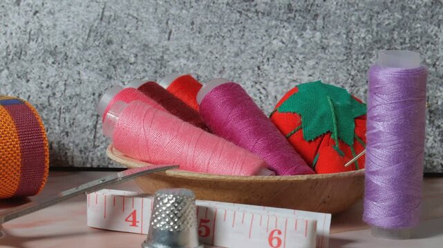 sewing tools, needle, bobbins, colored thread, sewing supplies