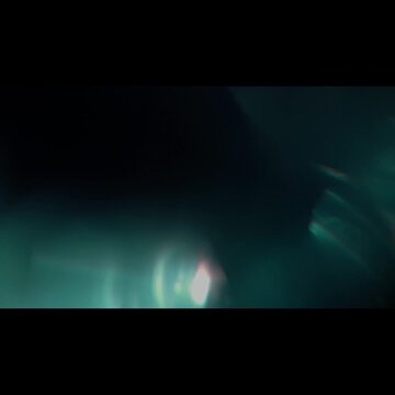 multi type of light leaks on black background with copy space. Studio lens flare bokeh effect. 4k video ubtle dust particles, and a gentle leak of light from a real lens 02.