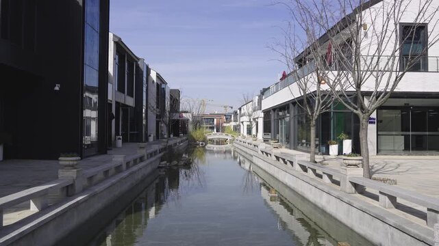 Modern Architecture Reflected in a Serene Urban Waterway with Minimalist Design Elements  