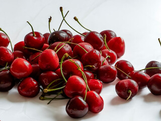 Fresh sweet cherries on white marble background with copy space © Наталия Чернова