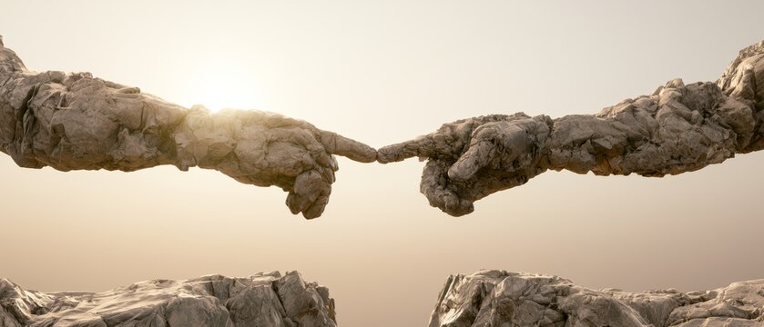 Sculpture of two hands reaching towards each other with light shining in the background