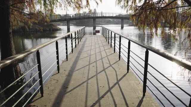 Tranquil Waterfront Pier: A Scenic View of the Calm River in Autumn  