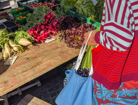 Older Woman Buying Fresh Organic Vegetables at a Farmers' Market in the City