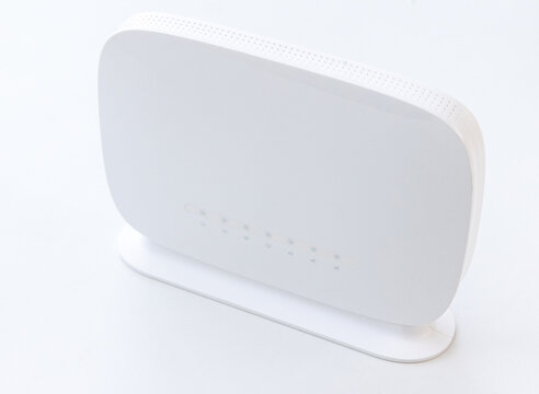Modern white wireless internet router on a white background