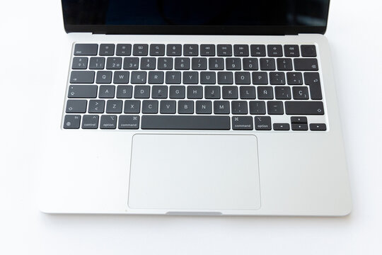Modern silver laptop keyboard and trackpad top view close up