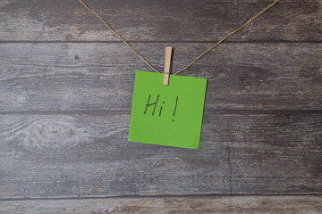 green square paper with the word hi written on it © Ana Maria