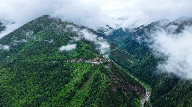 Aerial view of the summer landscape in Shuangqiao Valley Scenic Area of Mount Siguniang, Aba Prefecture, Sichuan, China, with mist-shrouded mountains