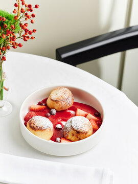 Vanilla cream puffs with berry sauce and fresh fruit, dessert menu, fine dining experience