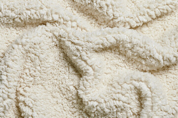 Close-up view of cozy curled white wool fibers texture © Clint