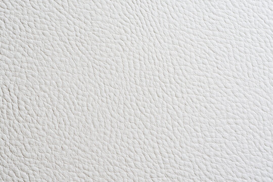 Detailed close-up of white embossed faux leather texture