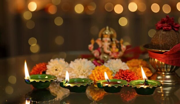 Female's hand keeping Diya in puja room for Laxmi-Ganesh worship on Diwali - Lord Ganesh puja Goddess Laxmi puja. Woman's hand keeping beautiful Diya ... See More