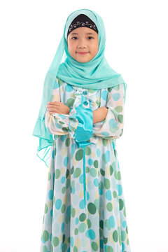 Half length portrait of confident young Asian Muslim girl crossing arms isolated on white background.