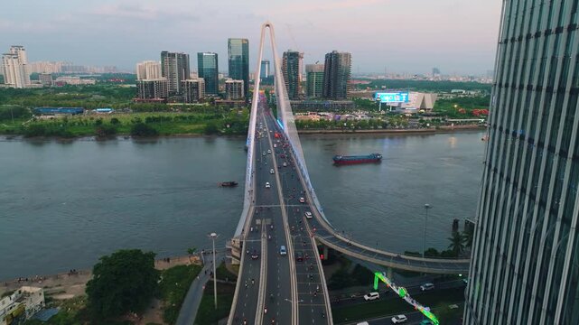 Aerial Shot of Ba Son Bridge Crossing Saigon River in Ho Chi Minh City
Shows evening road traffic commuting across the bridge connecting District 1 with the Thu Thiem urban area against a modern high-