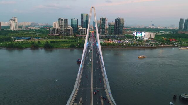 Aerial Shot of Ba Son Bridge Crossing Saigon River in Ho Chi Minh City
Shows evening road traffic commuting across the bridge connecting District 1 with the Thu Thiem urban area against a modern high-