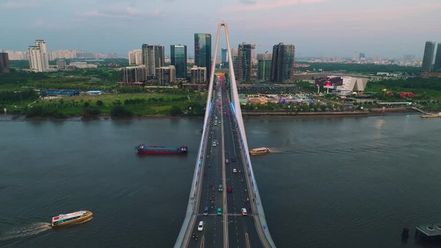 Aerial Shot of Ba Son Bridge Crossing Saigon River in Ho Chi Minh City
Shows evening road traffic commuting across the bridge connecting District 1 with the Thu Thiem urban area against a modern high-