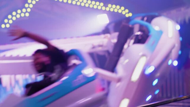 close up of fast spinning carnival ride at night