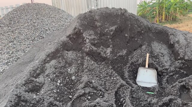 Pile of black sand and crushed stones at a building construction site